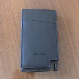 A slim cardholder wrapped in leather with a removable cash strap.